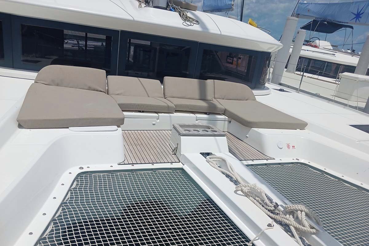 A sun deck with a seating area, a control panel, and a water filtration system.