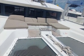 A sun deck with a seating area, a control panel, and a water filtration system.