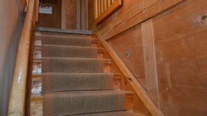 A wooden staircase with a handrail, carpeted steps, and a wooden wall with a window. - Rehweid (2. Stock) Appartement/Fewo, Dusche oder Bad, WC 5-Bettwohnung by Interhome (Gstaad)