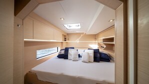 A compact, well-lit cabin with a bunk bed, a skylight, and built-in storage. - Sun-Kissed Sailing Adventure in Sibenik, Croatia (Primošten)