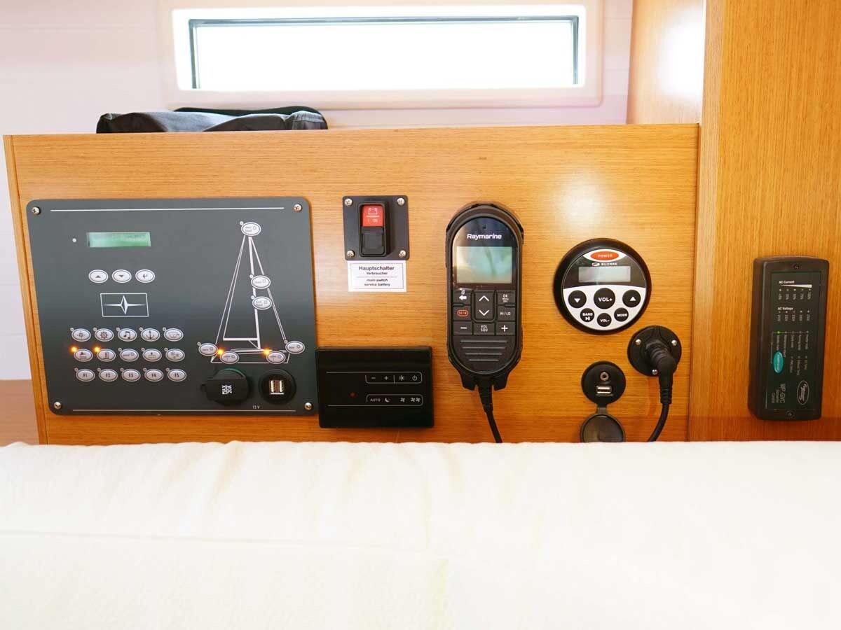 A control panel with a navigation chart, a communication device, and a power outlet.