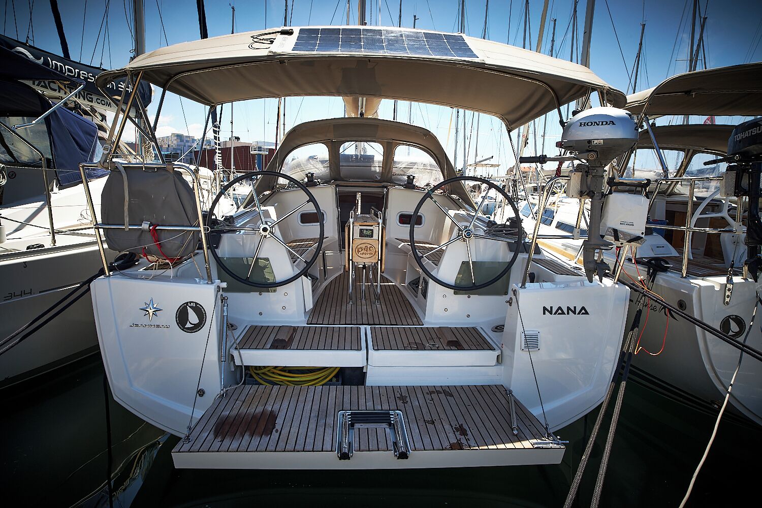 A boat deck with a steering wheel, a small table, and a solar panel.