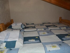 A single bed in a room with a wooden headboard and a plain wall. - Jacqueline 24 Appartement/Fewo, Dusche oder Bad, WC 5-Bettwohnung by Interhome (Gstaad)
