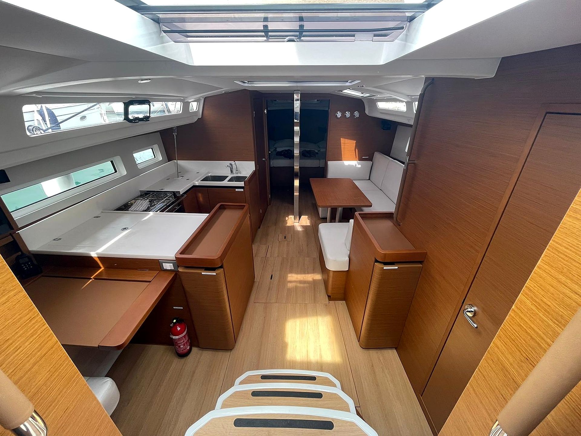 A compact galley with a sink, stove, and storage cabinets.