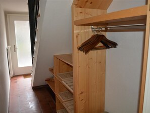 A wooden closet with shelves and a hanging rod. - Oberland Nr. 19 Appartement/Fewo, Dusche oder Bad, WC 6-Bettwohnung by Interhome (Gstaad)
