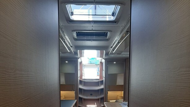 A narrow corridor with a skylight, wooden flooring, and seating areas. - Sun-kissed Sailing Adventure in Split-Dalmatia, Croatia (Trogir)