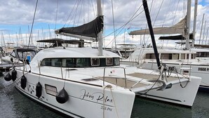 A white yacht named 'Johnny Relax' docked at a marina with other boats. - Sun-Kissed Sailing Adventure in Northern Croatia (Punat)