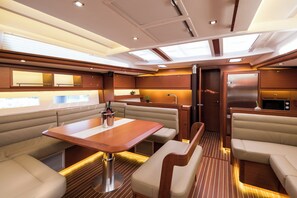 A boat interior with a dining area, seating, a kitchen, and a galley. - Sun-Kissed Sailing Adventure in Sibenik, Croatia (Primošten)
