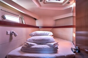 A compact, well-lit cabin with a bunk bed, a window with curtains, and a small bedside table. - Sun-Kissed Sailing Adventure in Zadar, Croatia (Biograd na moru)