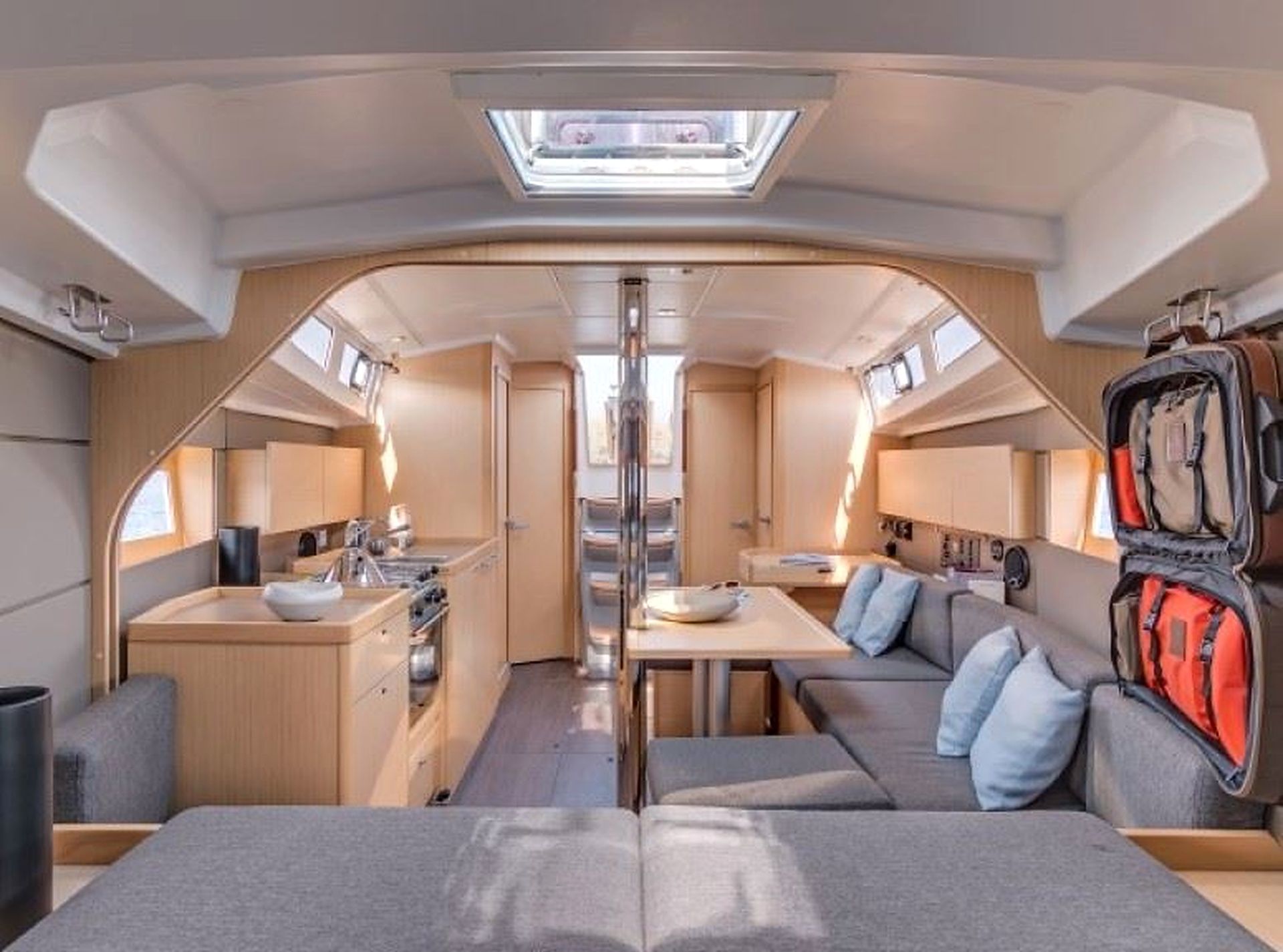 A compact interior with a kitchenette, a dining area, and seating.