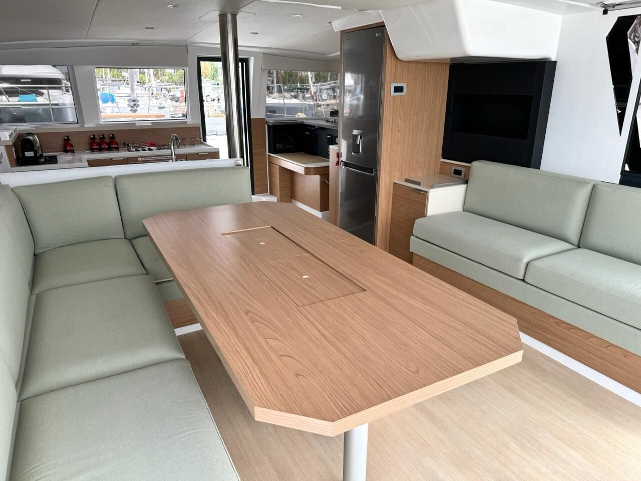 A compact living space with a central table, a sofa, a kitchenette, and a seating area.