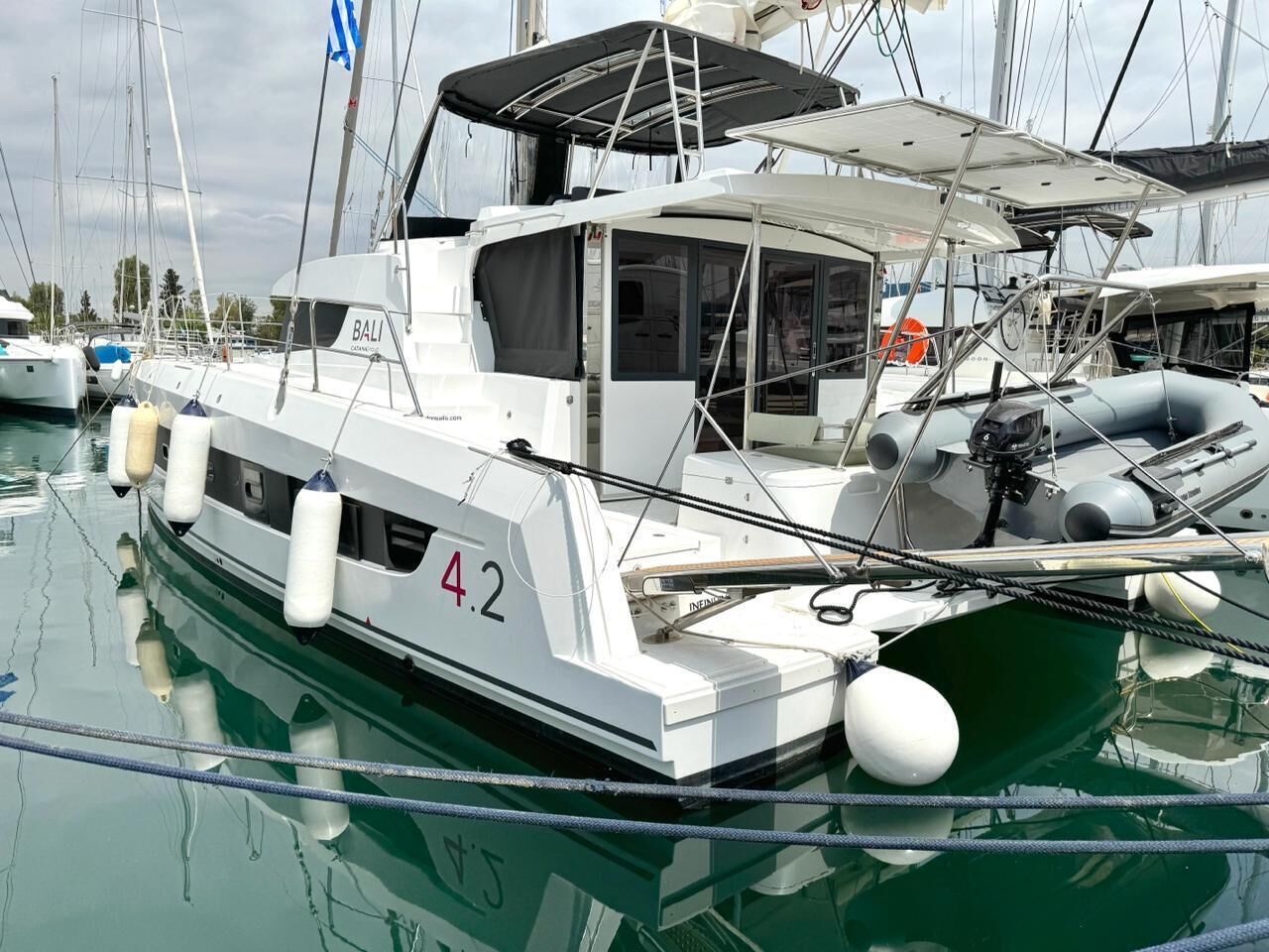Un yate blanco con el número 4.2, una cubierta techada y una cabina.