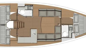 A boat layout with a dining area, kitchen, and seating arrangements.