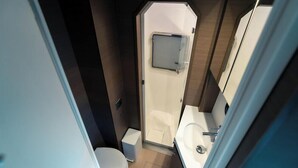 A compact bathroom with a toilet, sink, and shower. - Sun-Kissed Sailing Adventure in the Ionian Islands, Lefkada (Lefkada)