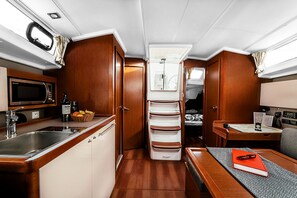 A compact kitchen with a microwave, a refrigerator, and a sink.