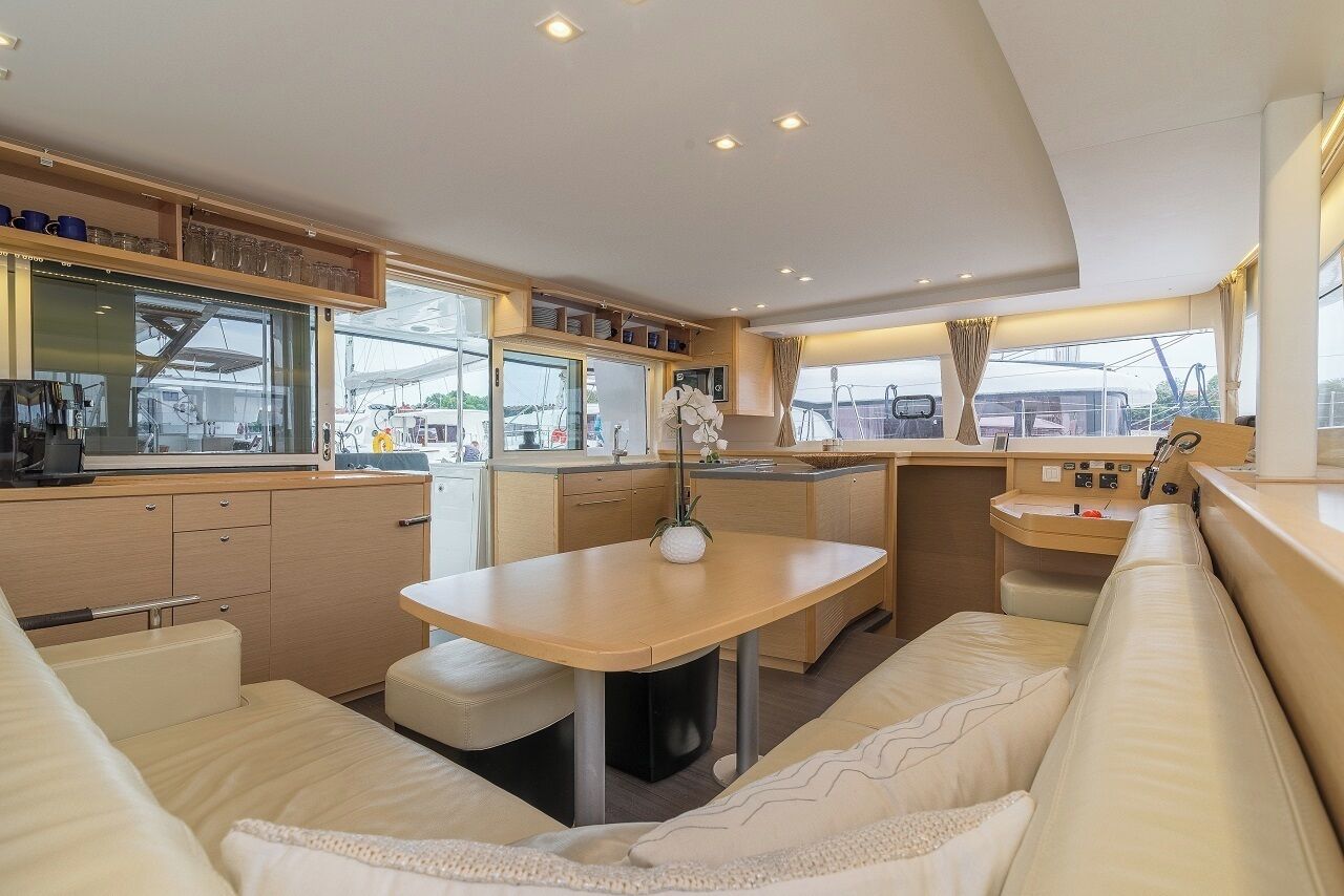 A compact kitchen with a dining area, a small table, and a sofa.