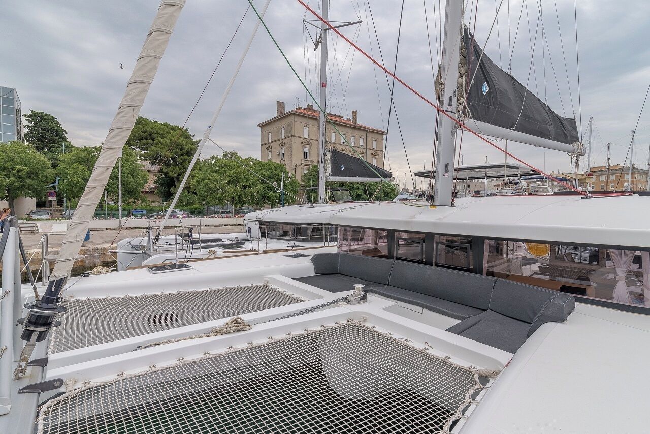 A sailboat with a covered deck, a mast, and rigging.