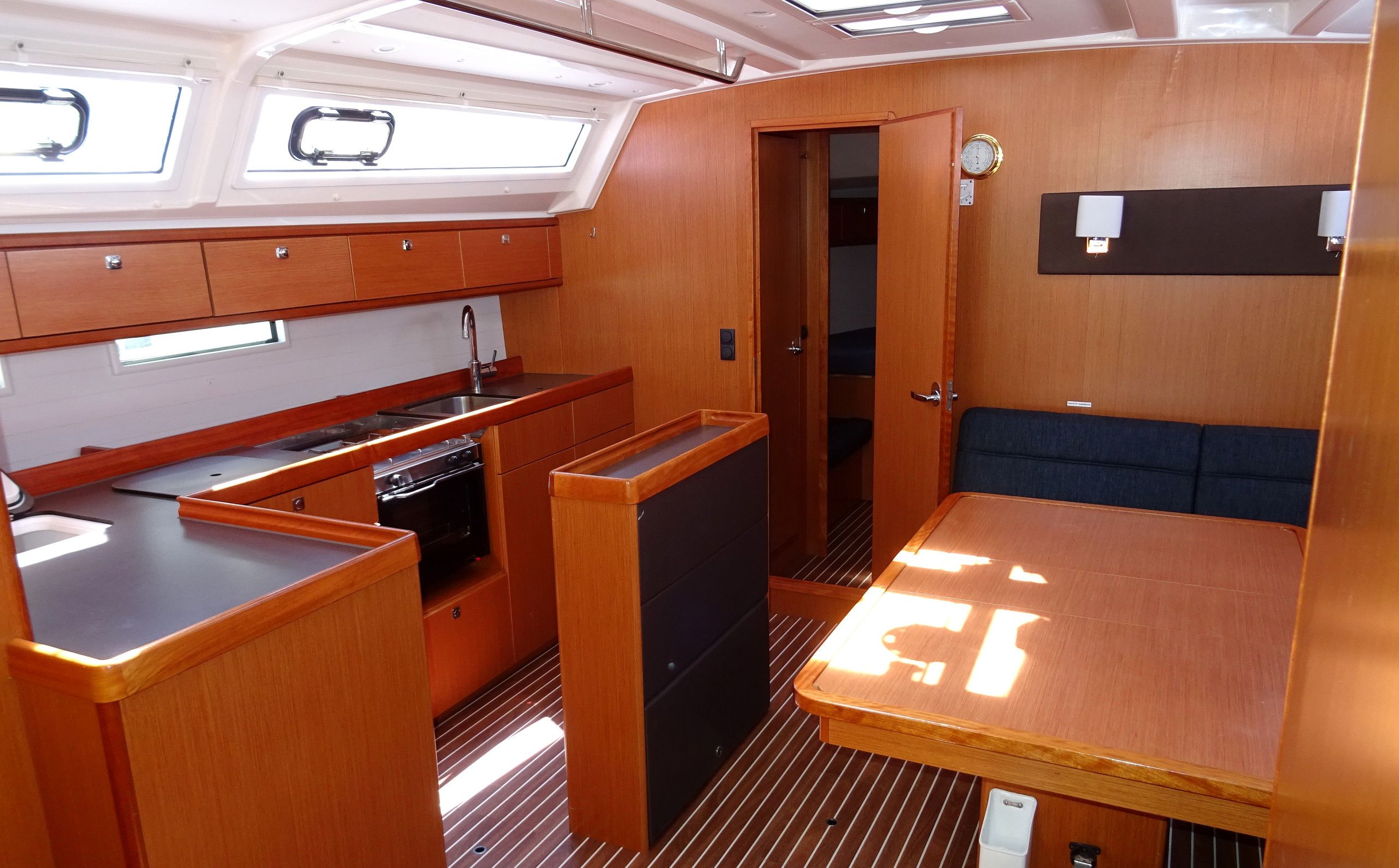 A compact kitchen with a sink, stove, and storage cabinets.