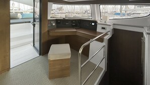 A boat's interior with a control panel, seating, and a view of the marina. - Sun-Kissed Sailing Adventure in Islas Sarónicas (Alimos)