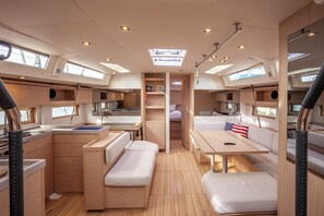 A compact galley with a sink, stove, and storage cabinets.