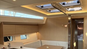 Eine kleine Küche mit Spüle, einer Essecke und einem eingebauten Kühlschrank.