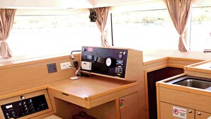 A compact kitchenette with a sink, a control panel, and a small seating area. - Sun-Kissed Sailing Adventure in Northern Croatia (Punat)