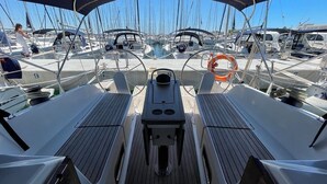 A marina with multiple sailboats docked, a steering wheel, and a lifebuoy. - Sun-Kissed Sailing Adventure in Zadar, Croatia (Bibinje)