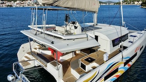 A yacht with a covered deck, a steering wheel, and a cabin area. - Sibenik Sun-soaked Sailing: A Luxurious Croatian Voyage (Pirovac)