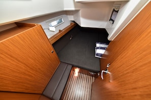 A compact interior with a small window, a control panel, and a cushioned sleeping area. - Sun-Kissed Sailing Adventure in Zadar, Croatia (Zadar)