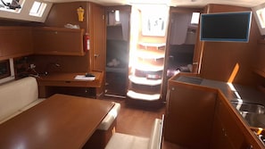 A compact interior with a kitchenette, a small seating area, and a window providing natural light.