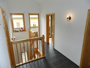 A wooden staircase leading to a balcony with a view of the outside. - Panorama, Chalet Appartement/Fewo, Dusche oder Bad, WC 7-Bettwohnung by Interhome (Zweisimmen)