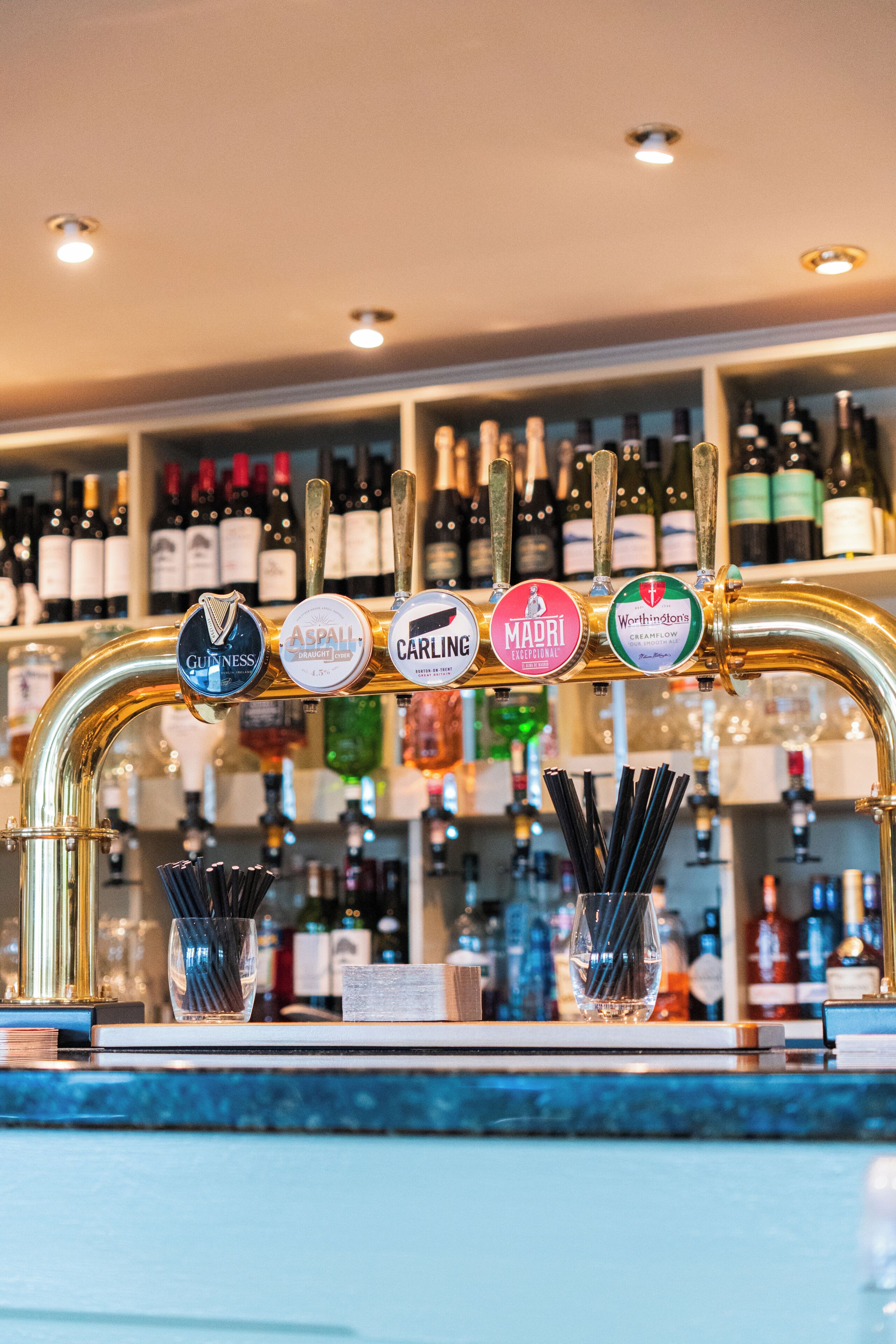 A bar with multiple taps labeled with different brands.