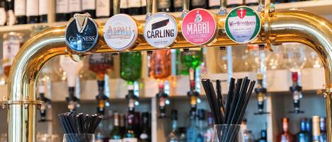 A bar with multiple taps labeled with different brands.