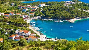 A coastal village with houses, a marina, and clear blue waters. - Sun-Kissed Sailing Adventure in Zadar, Croatia (Drage)