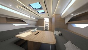 A modern interior with a central table, seating, skylights, and built-in storage. - Sibenik Sun-soaked Sailing: A Luxurious Croatian Voyage (Pirovac)