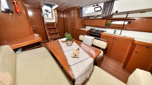 A compact kitchen with a microwave, stove, and sink. - Sun-Kissed Sailing Adventure in Zadar, Croatia (Bibinje)