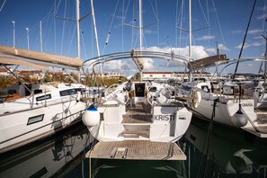 A marina with multiple boats docked, including a boat named 'KRISTI'. - Sibenik Sun-soaked Sailing: A Luxurious Croatian Voyage (Pirovac)