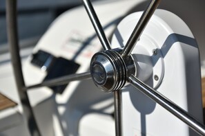 A close-up of a boat's steering mechanism with a metallic finish and a visible brand logo. - Sun-Kissed Sailing Adventure in Zadar, Croatia (Zadar)