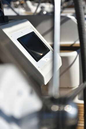 A control panel with a screen, likely for a boat's navigation or control system.