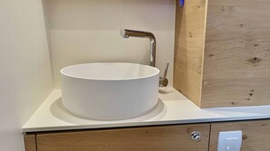 A bathroom with a white sink, a wooden cabinet, and a mirror. - Sibenik Sun-soaked Sailing: A Luxurious Croatian Voyage (Pirovac)