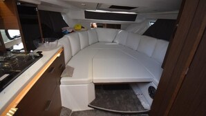 A boat interior with a kitchen area, a seating area, and a small window. - Sun-Kissed Sailing Adventure in Zadar, Croatia (Zadar)