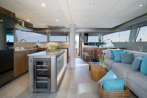 A modern yacht interior with a kitchen, dining area, and living space. - Sun-Kissed Sailing Adventure in Split, Croatia (Kaštel Gomilica)