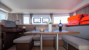 A compact kitchenette with a built-in stove, a small fridge, and a sink. - Sun-Kissed Sailing Adventure in Zadar, Croatia (Biograd na moru)