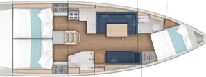 A boat interior with a dining area, a kitchen, a bathroom, and a sleeping area.