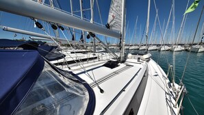 A sailboat docked at a marina with multiple masts and flags. - Sun-Kissed Sailing Adventure in Zadar, Croatia (Bibinje)