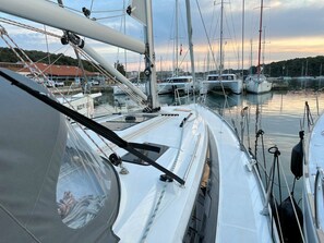A marina with multiple sailboats docked, a clear sky, and calm water. - Sun-Kissed Sailing Adventure in Istria, Croatia (Pula)