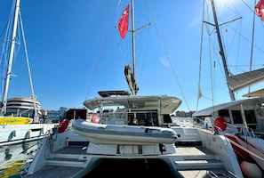 A sailboat docked at a marina with clear skies.