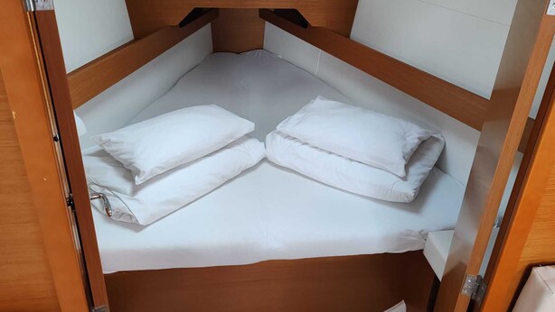 A compact, enclosed sleeping area with a bench-style bed and a headboard. - Sun-Kissed Sailing Adventure in Zadar, Croatia (Drage)