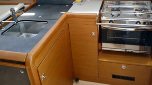 A compact kitchenette with a microwave, sink, and gas stove. - Sun-Kissed Sailing Adventure in Zadar, Croatia (Drage)