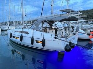 A marina with multiple sailboats docked, including a white boat named 'CHRISTINE' with a blue interior. - Sun-Kissed Sailing Adventure in Istria, Croatia (Pula)